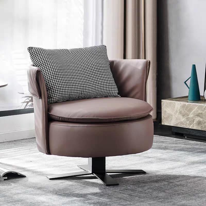 Luxury-lite modern minimalist rotating single sofa chair customized for a relaxation area in a bedroom, circular-shaped leather chair for leisure.