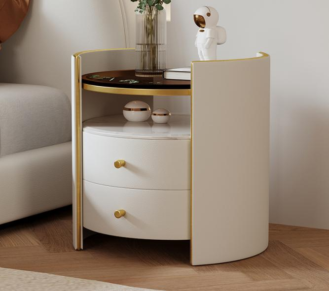 Light luxury cream style bedside table with round shape, simple and modern design. Bedroom bedside cabinet with minimalist granite board and dark glass storage cabinet.