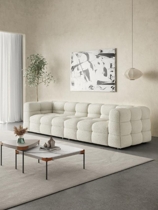 Zen style fabric sheepskin and cotton candy sofa for a three-person seating arrangement in an Italian retro-style living room with cream color tone.