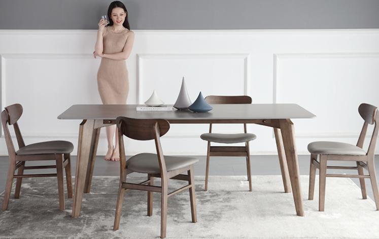 Solid wood granite slab dining table with modern and minimalist design, featuring white wax wood solid legs and a rectangular shape with a glossy finish. The tabletop is made of white granite slab.