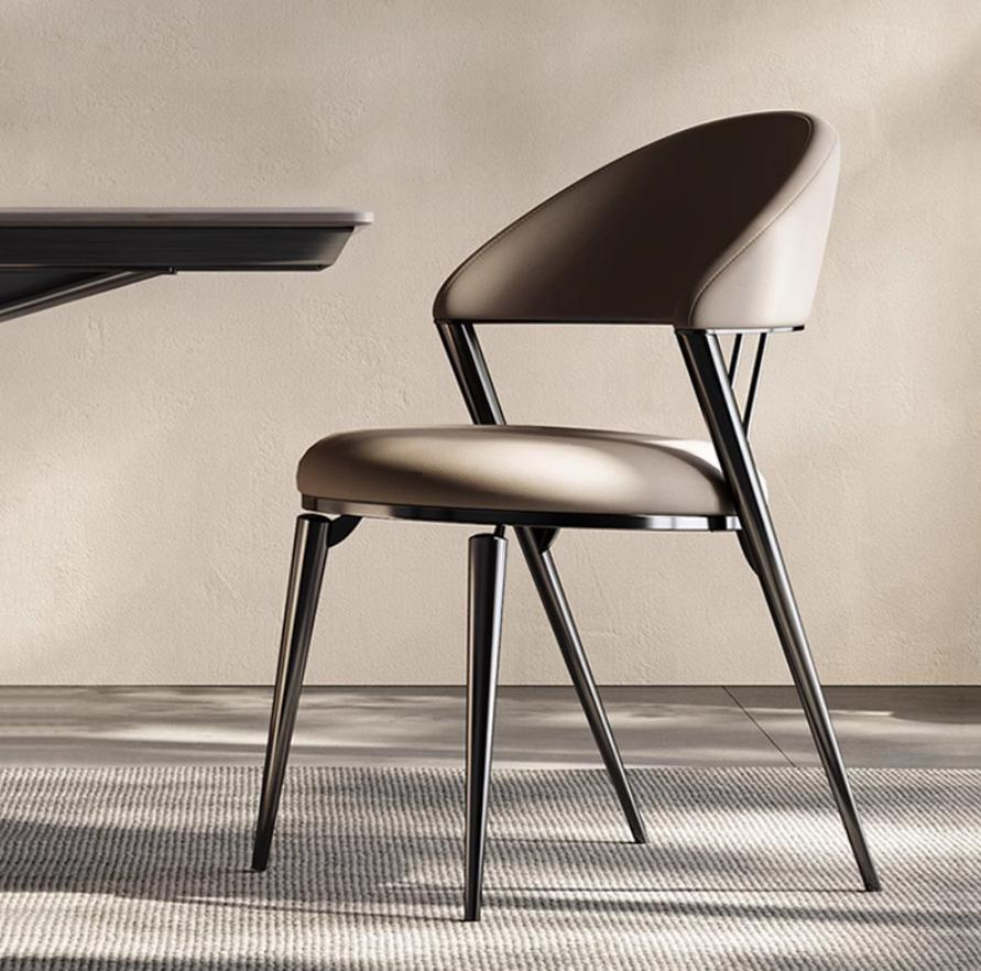 Nordic dining chairs, modern and minimalist, with a touch of French light luxury and sophistication. The dining table is upholstered with leather, and the chairs have backrests. It's suitable for a sophisticated dining room.