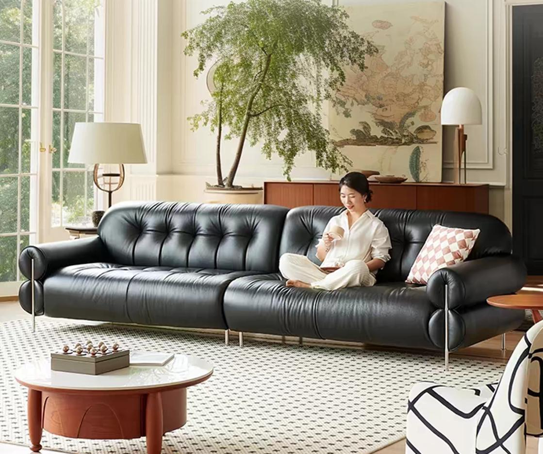 Black sugar-colored clouds are arranged in a straight line on the top layer of the leather sofa. It is a black leather luxury designer sofa.